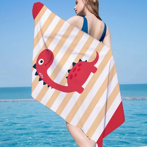 Detail view of large microfiber beach towel with red dinosaur and striped pattern by a pool