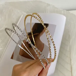 Elegant crossed rhinestone headbands in gold and silver finish with minimalist dual-layer design
