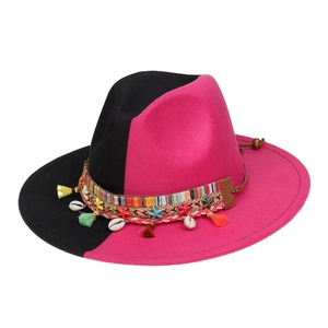 Detail of the woven ethnic band with shells and tassels on the black and pink fedora