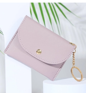 Close-up of lilac PU leather wallet with gold button closure and metallic keychain