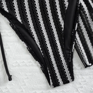 Close-up of black and white striped crochet bikini bottom with textured knit detail