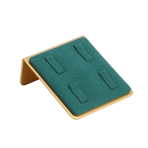 Golden metal 4-slot ring display stand with dark green velvet surface on white background