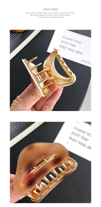 Detail of acetate shark hair clips with strong metal spring and gold trim
