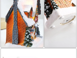 Detail view of a light-up resin Christmas house with battery compartment and switch