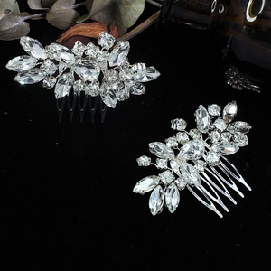 Close-up of silver leaf bridal hair combs with sparkling rhinestones on black background