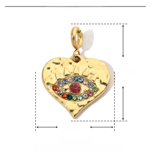 Macro shot of gold heart devil eye pendant with size specs and red rhinestone detail