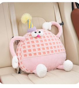 Detail of pink fleece monster car headrest featuring textured fabric and quirky limbs