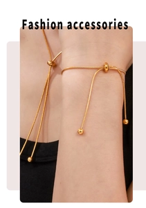 Detail of 18K gold-plated snake chain with adjustable slider buckle and bead tassel
