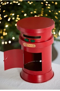Detail of red festive iron postbox ornament featuring gold POSTMAIL label and holly leaves