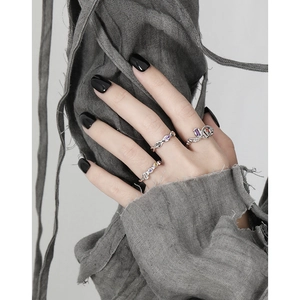 Minimalist geometric silver rings set with purple and orange zircon stones on model