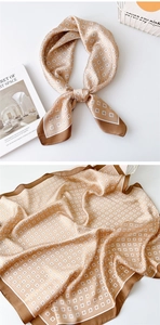 Detail of champagne square silk scarf with brown border and geometric patterns