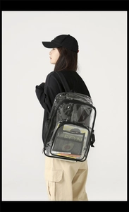 Side view of large clear PVC backpack with black straps showing transparent texture