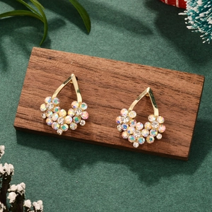 Close-up of luxury gold-plated teardrop earrings with colorful crystal rhinestones