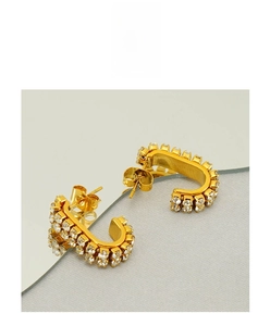 Detailed close-up of C-shaped gold-plated earrings featuring double-row crystal pave setting