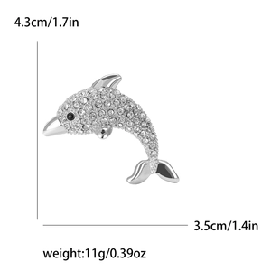 Detail showing dolphin brooch size 4.3x3.5cm and 11g weight with rhinestone inlay