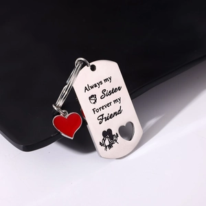 Macro shot of stainless steel military tag with Always my Sister engraving and heart charm