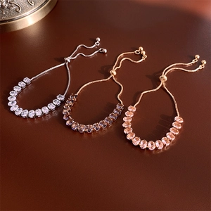 Detail of adjustable slider bracelet with oval-cut zircons in pink, white, and champagne