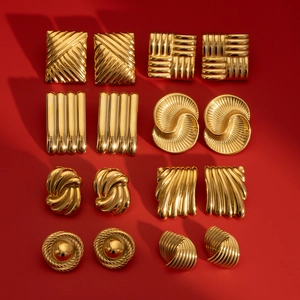 Set of 8 pairs gold geometric stainless steel earrings displayed on red background