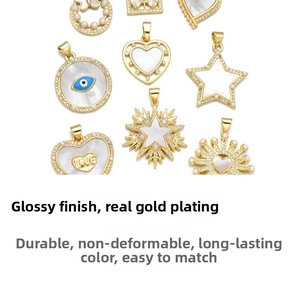 Detailed view of 18K gold plated heart and evil eye pendants with pearls and zircons