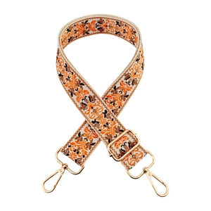 Ethnic style woven shoulder strap for bags with golden metal hooks on white background