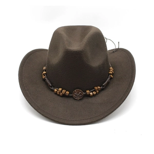 Detail of dark brown western cowboy hat with ethnic beaded band and wooden buckle