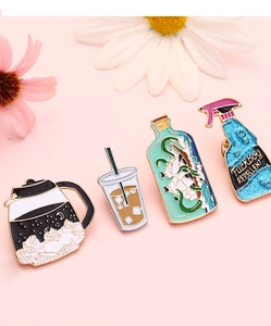Macro shot of 4-piece enamel pins featuring coffee, bottles, and spray design