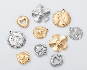 Detailed close-up of mixed gold and silver stainless steel flower and heart pendants