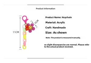 Detailed view of colorful acrylic keychain with purple smiley flower and red gummy bear charms