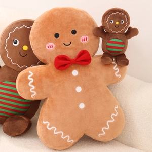 Close-up of plush gingerbread man toy with red bow tie on soft white textured surface