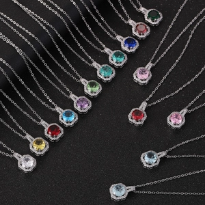 Macro shot of colorful perfume bottle pendants in fan-shaped layout on black texture
