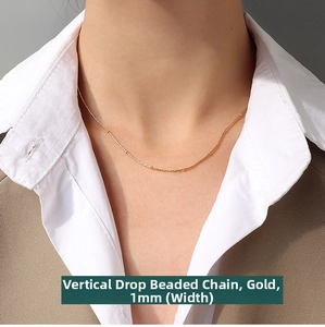 Detail of 1mm gold-plated titanium steel box bead chain worn on a necklace model