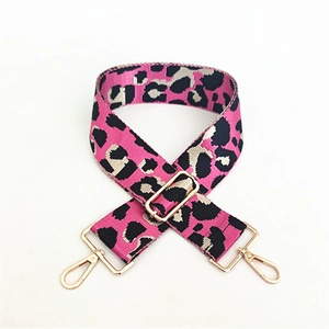 Macro detail of leopard pattern strap with adjustable golden metal buckle and lobster clasp