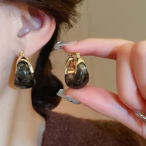 Maillard U-shaped resin earrings with gold-plated metal accents for a vintage look