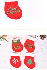 Close-up of mini red Christmas stockings with glitter letters and snowflake decor