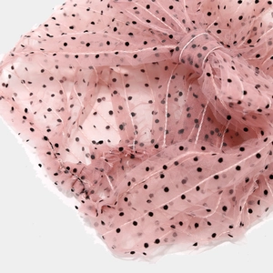 Close-up of pink mesh turban with black polka dots featuring delicate pleats and stitching