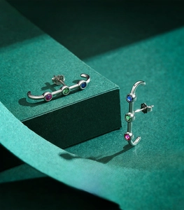Detailed shot of S925 sterling silver ear climbers with blue green and red gemstones