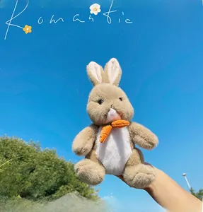 Close-up of a brown plush bunny toy with white soft fur accents and an orange carrot accessory