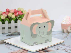 Pink and green cartoon elephant gift box for candies and baked goods on a display plate