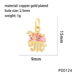 Detailed view of jellyfish pendant with gold plating and pink gemstone inlay
