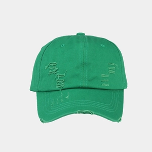 Close-up of bright green washed cotton baseball cap with distressed torn details