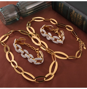 Detailed view of luxury gold interlocking necklace and diamond paved curb chain set