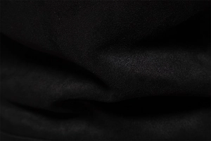 Close-up of black suede fabric texture showing the fine weave of the men's jacket