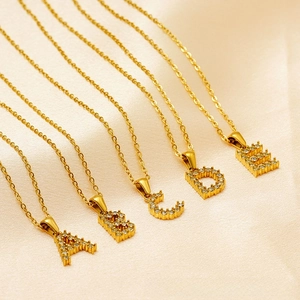 Detail of 18K gold plated initial necklaces A to E with micro-pave cubic zirconia crystals