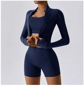 Three-piece navy blue yoga set featuring a zip-up jacket, sports bra, and high-waist shorts