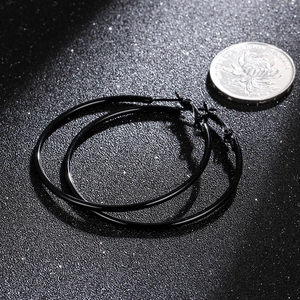 Minimalist large black hoop earrings with polished finish and secure pin clasp closure