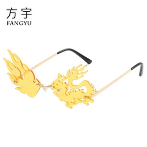 Detail of rimless gold dragon and flame shaped lenses with slim metal temples