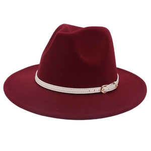 Close-up of burgundy wool felt fedora featuring white leather strap and gold buckle detail
