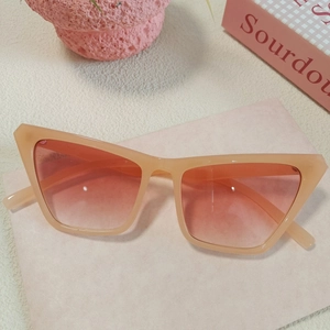 Detail of Y2K heart-shaped sunglasses with pink gradient lenses on minimalist background