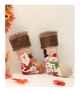 Close-up of linen Christmas stockings with 3D embroidery of Santa, deer and snowmen