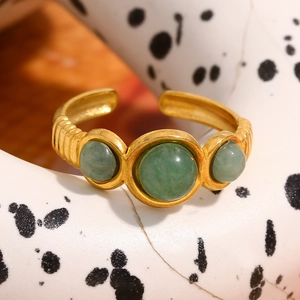 Close-up of vintage gold wavy ring band featuring three round green aventurine stones